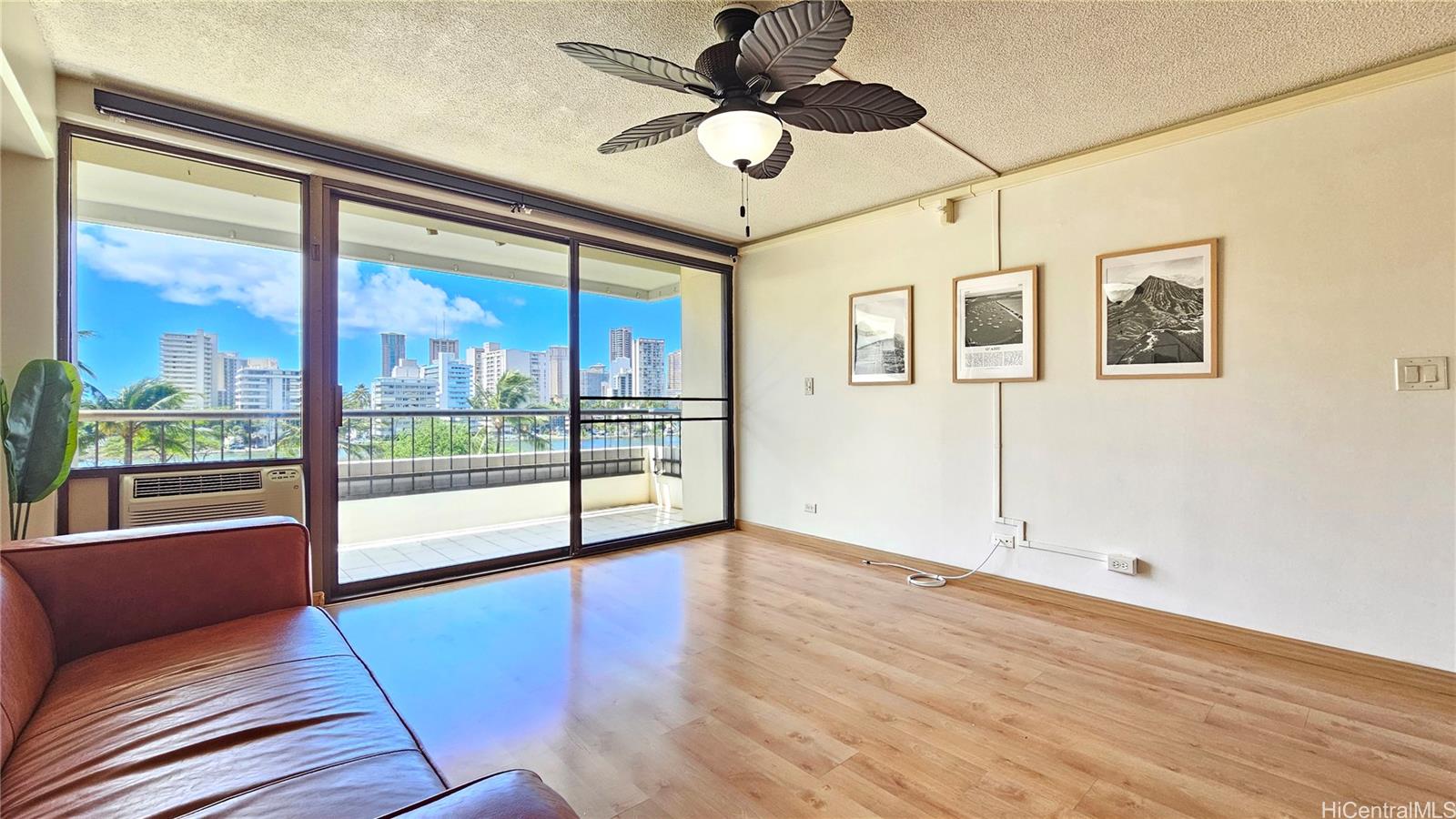 a view of a livingroom with a ceiling fan and window