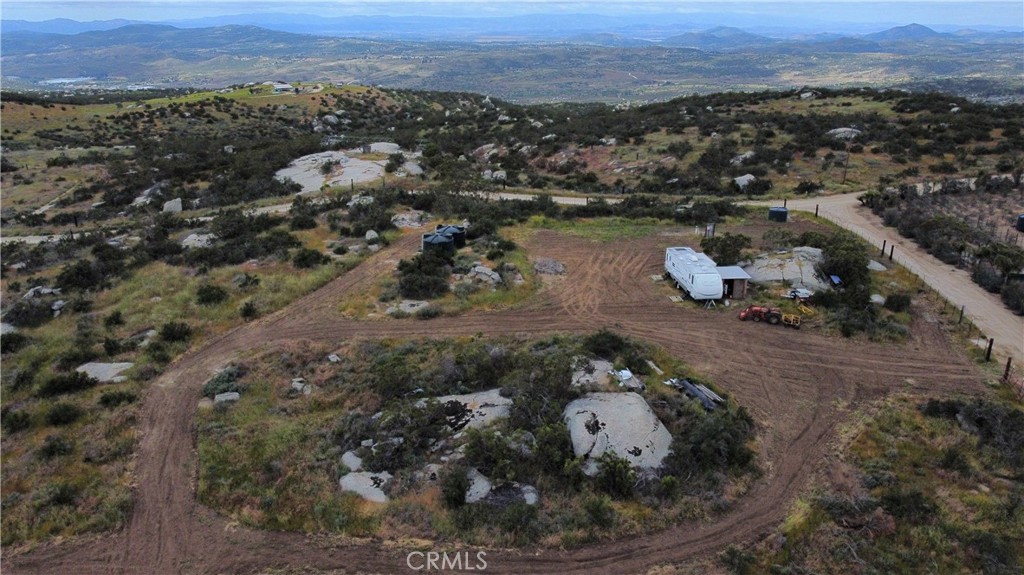 an aerial view of a house with a yard and lake view