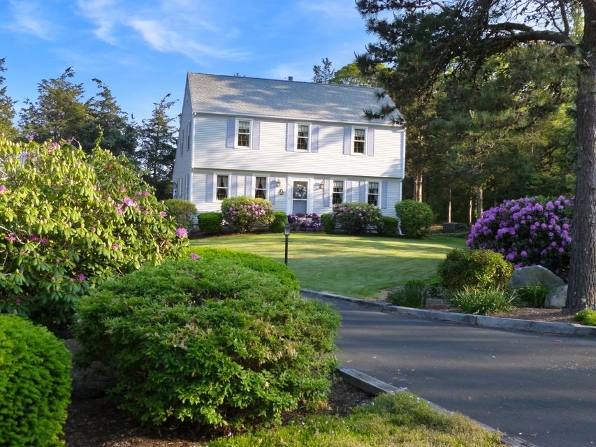 a front view of a house with a yard