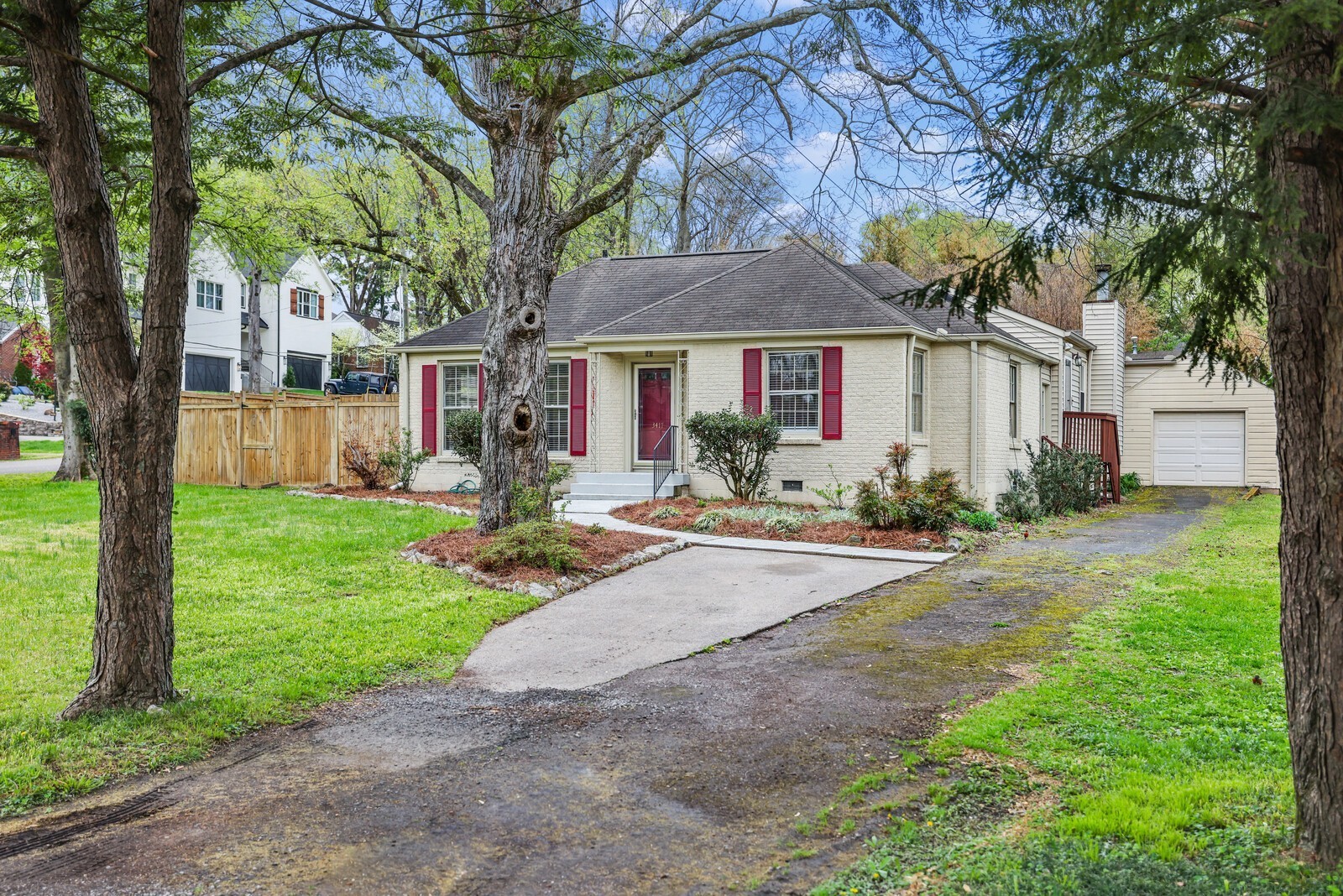 a front view of a house with yard and green space