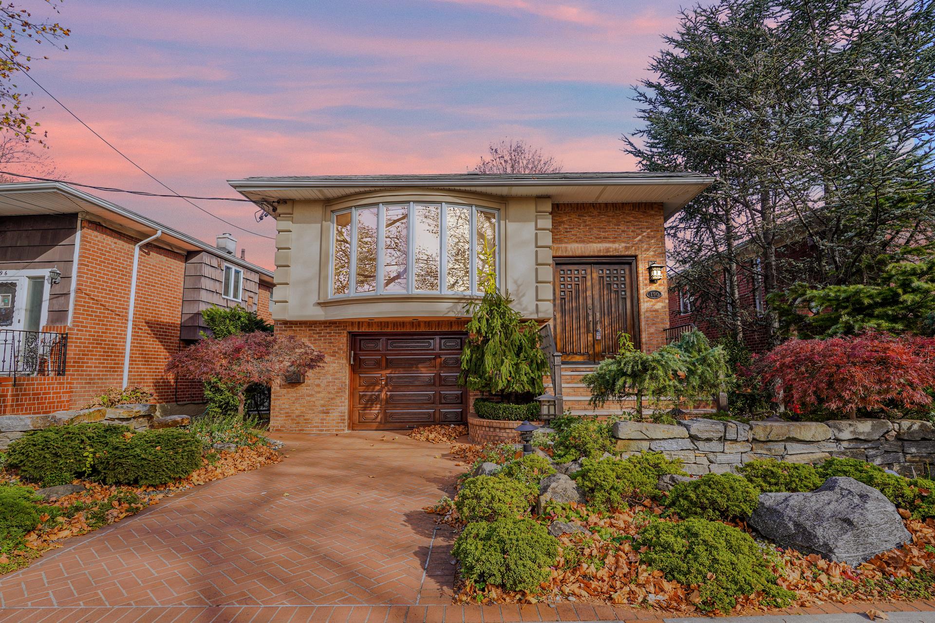 a front view of a house with a garden