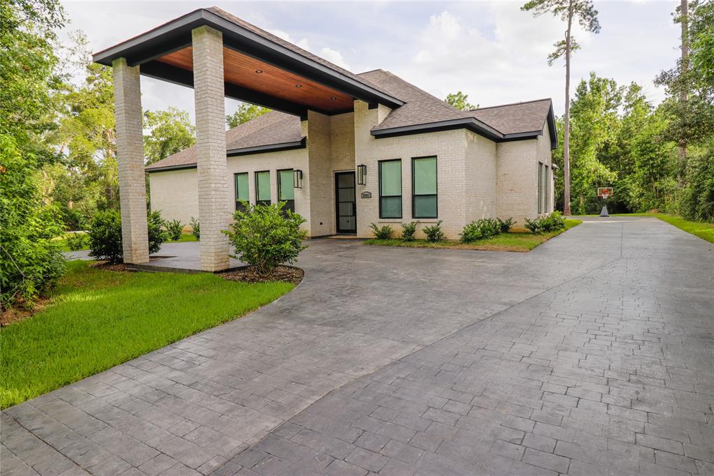 a front view of a house with a yard and trees