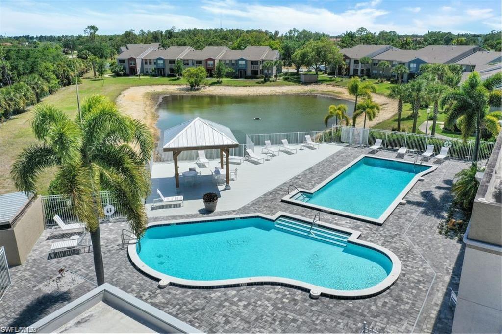 View of pool featuring a gazebo, a patio area, and a water view