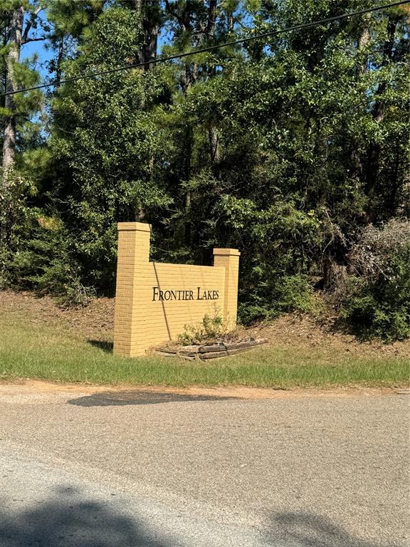 a sign board with a house and yard