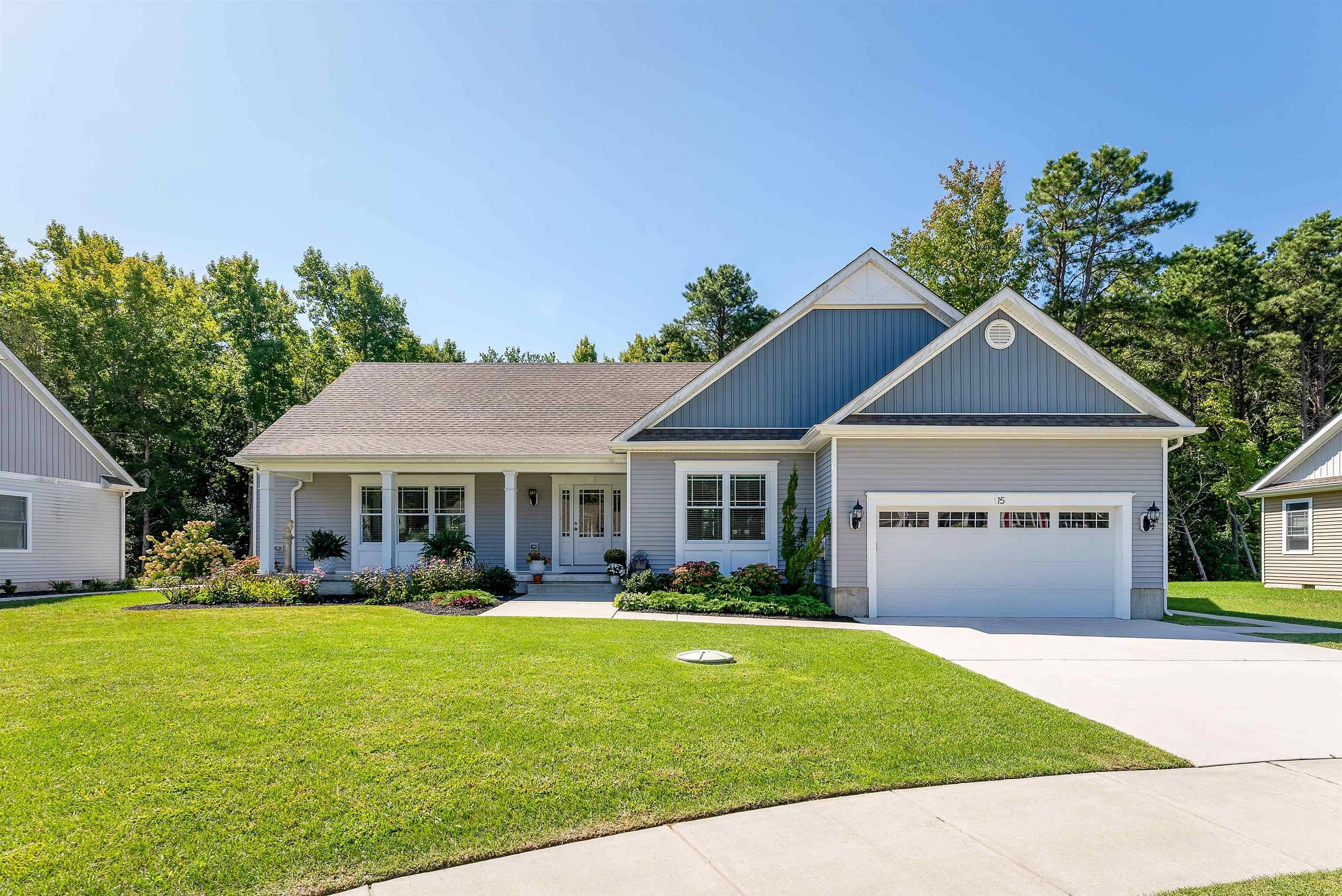 a front view of house with yard and green space