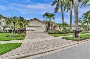 a front view of a house with a yard and palm trees