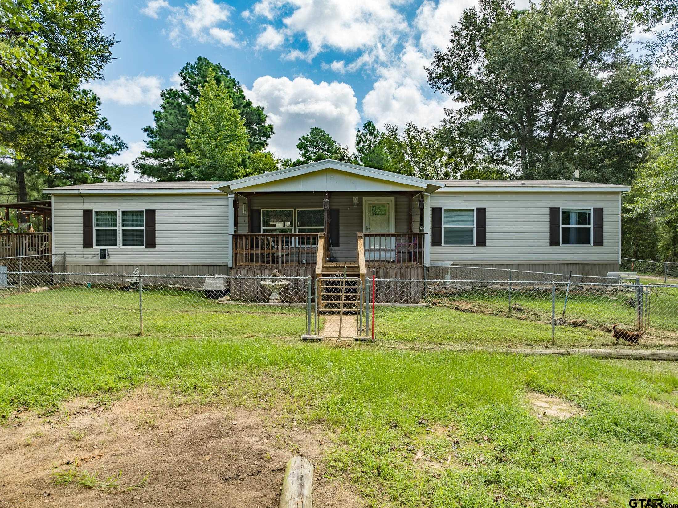 a view of a house with a backyard