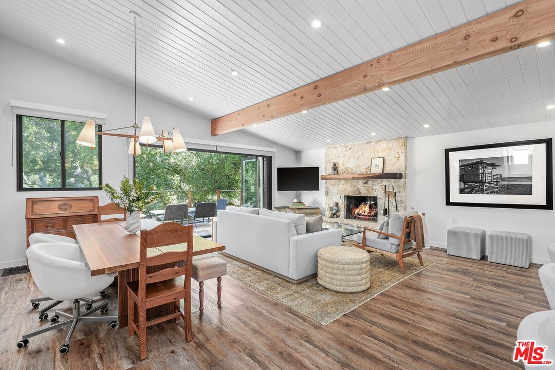 a living room with furniture a fireplace and a table