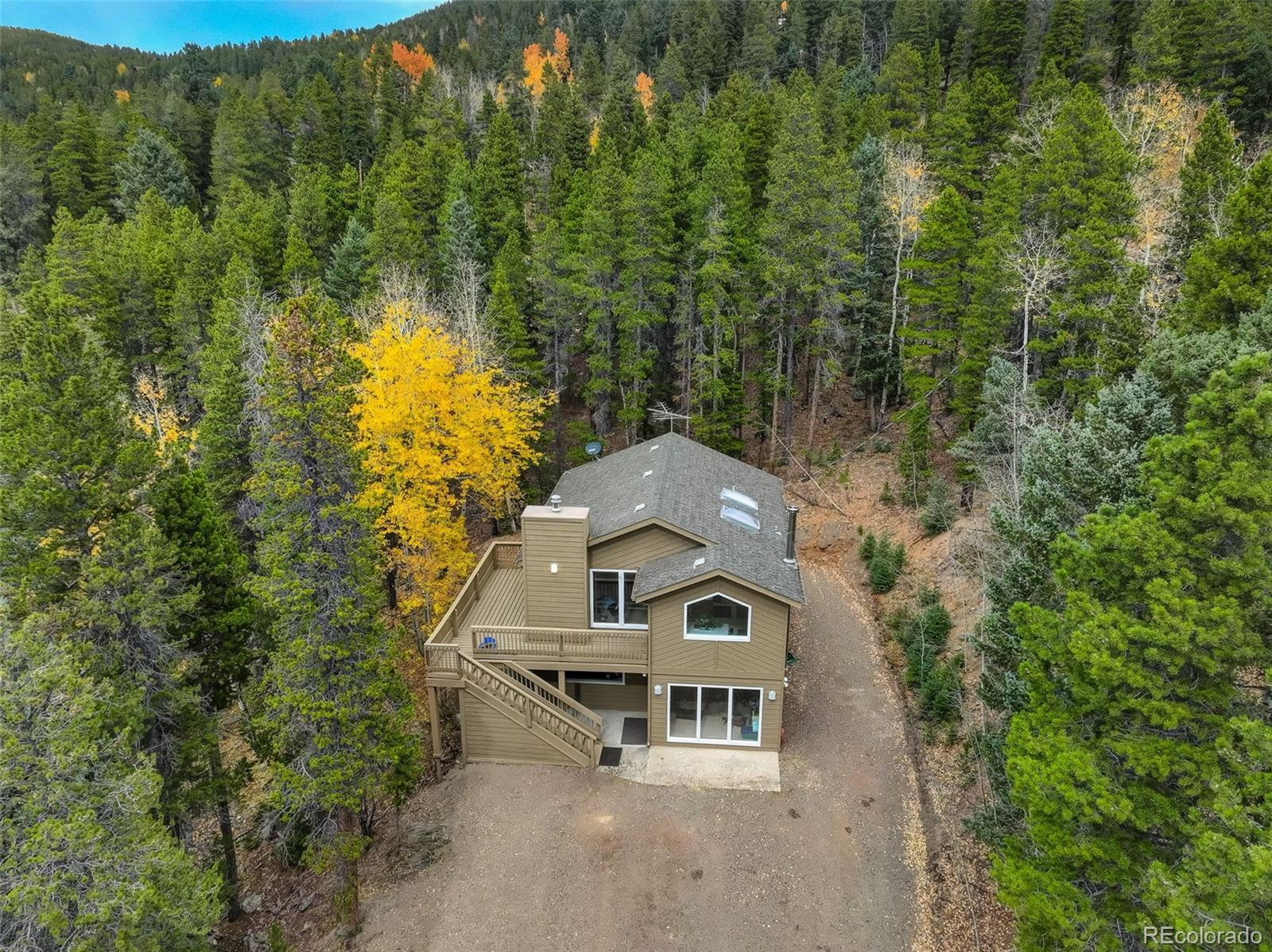 an aerial view of a house with a yard