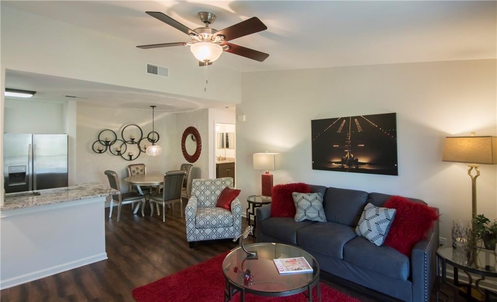 a living room with furniture and a wooden floor