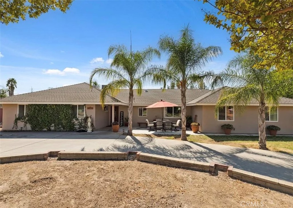 a front view of a house with swimming pool and porch