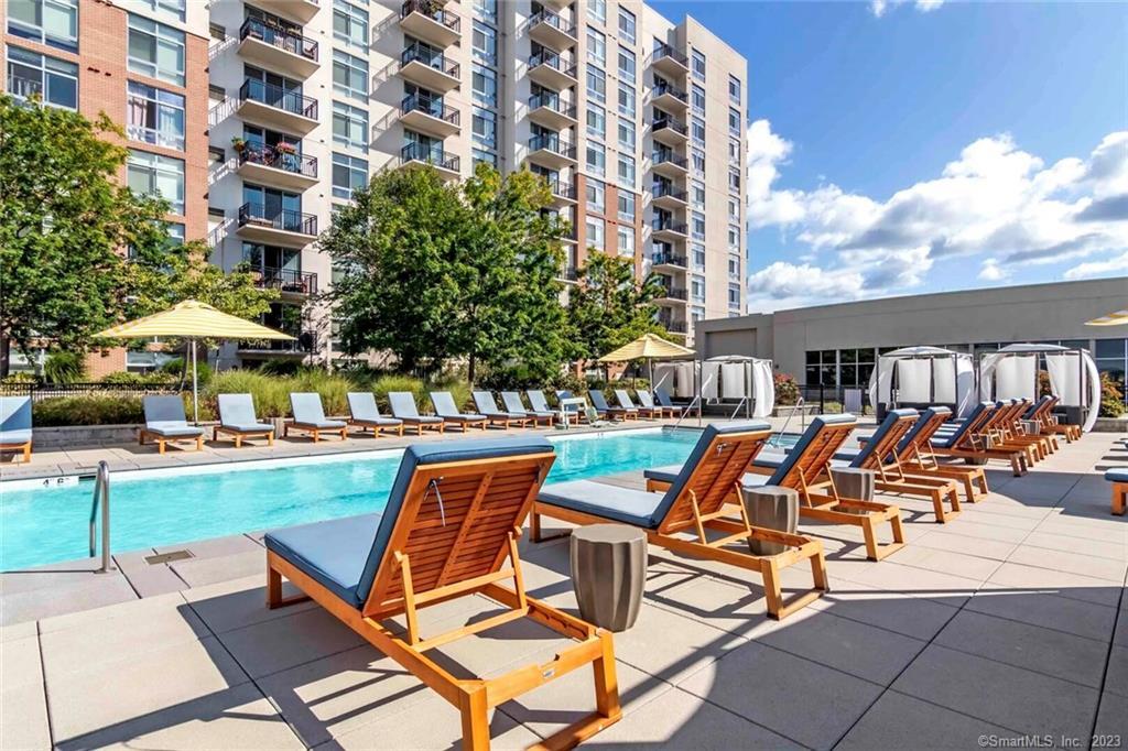 a view of a swimming pool with lounge chairs in patio