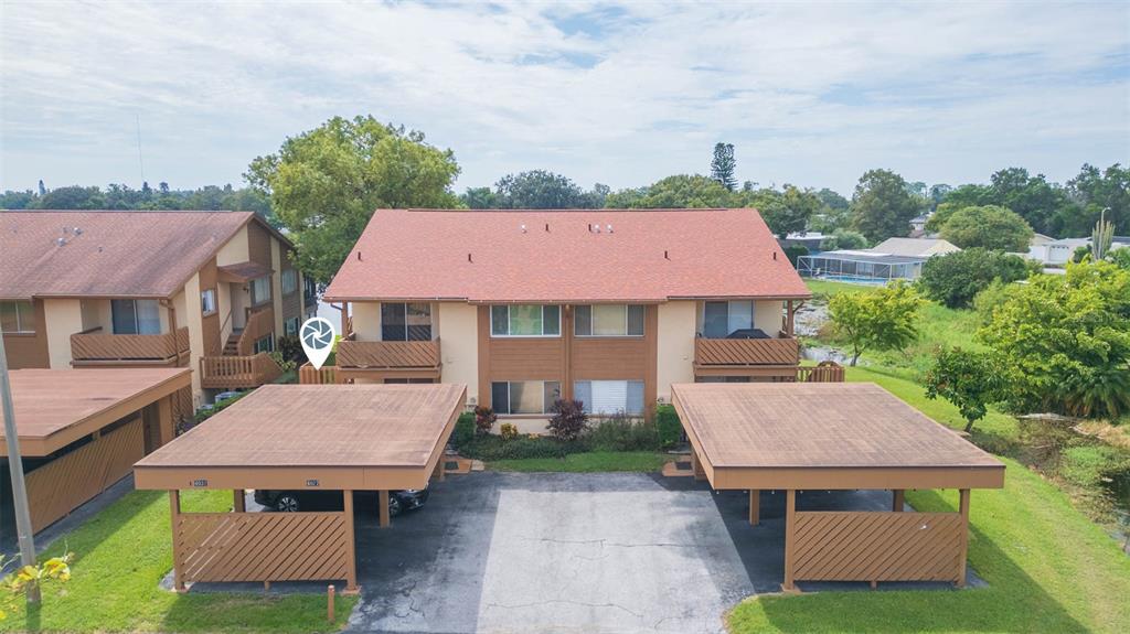 an aerial view of a house with yard and green space