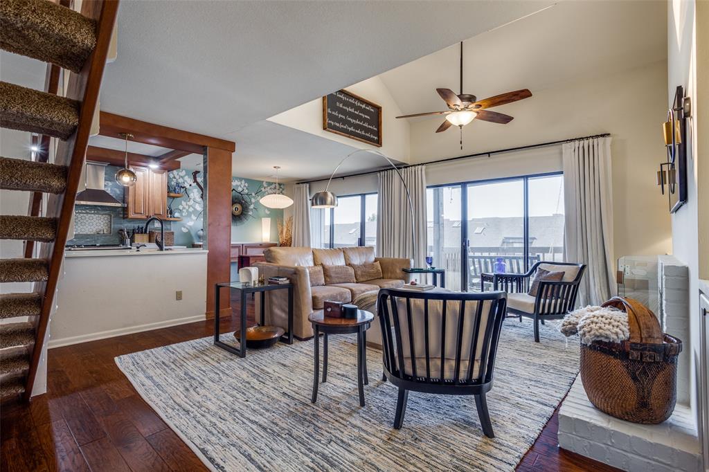 a living room with furniture a rug and a floor to ceiling window