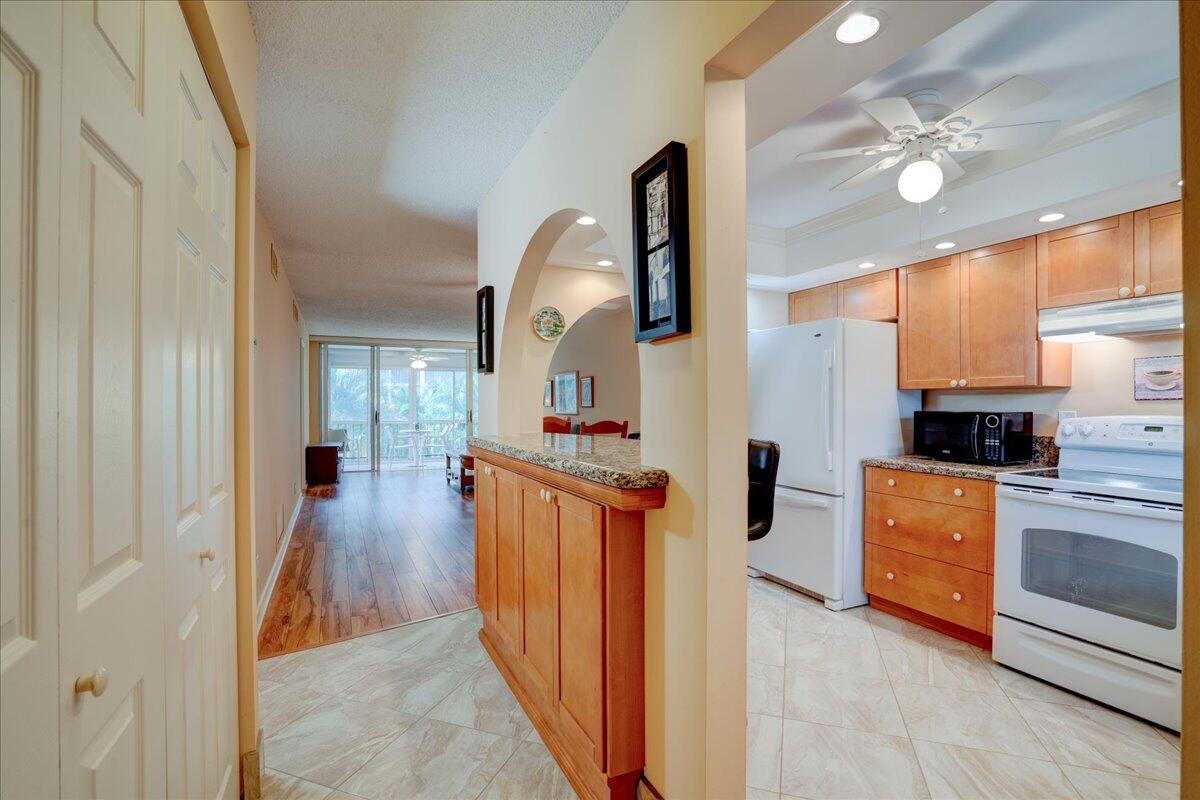 a kitchen with stainless steel appliances kitchen island wooden cabinets and stove