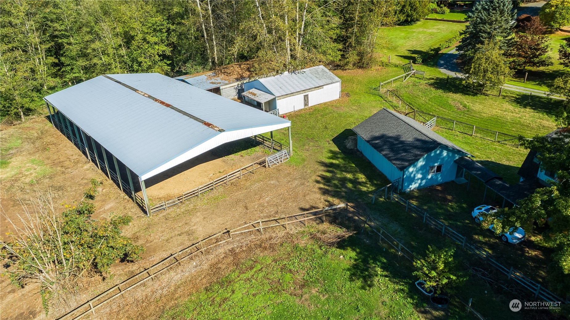 an aerial view of a house with a yard and lake view