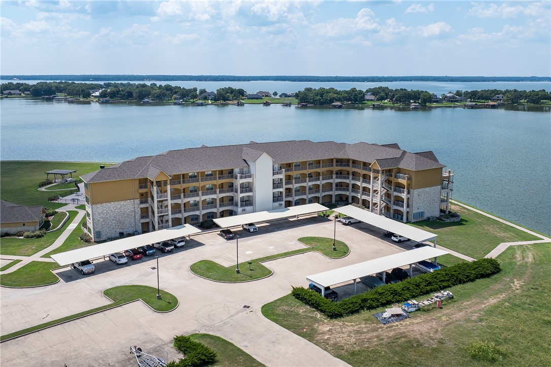 a view of a lake with couches in the patio