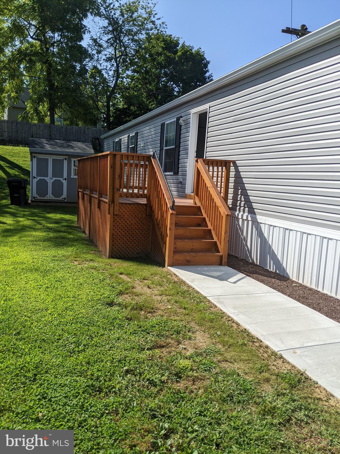 a view of a house with backyard and wooden fence