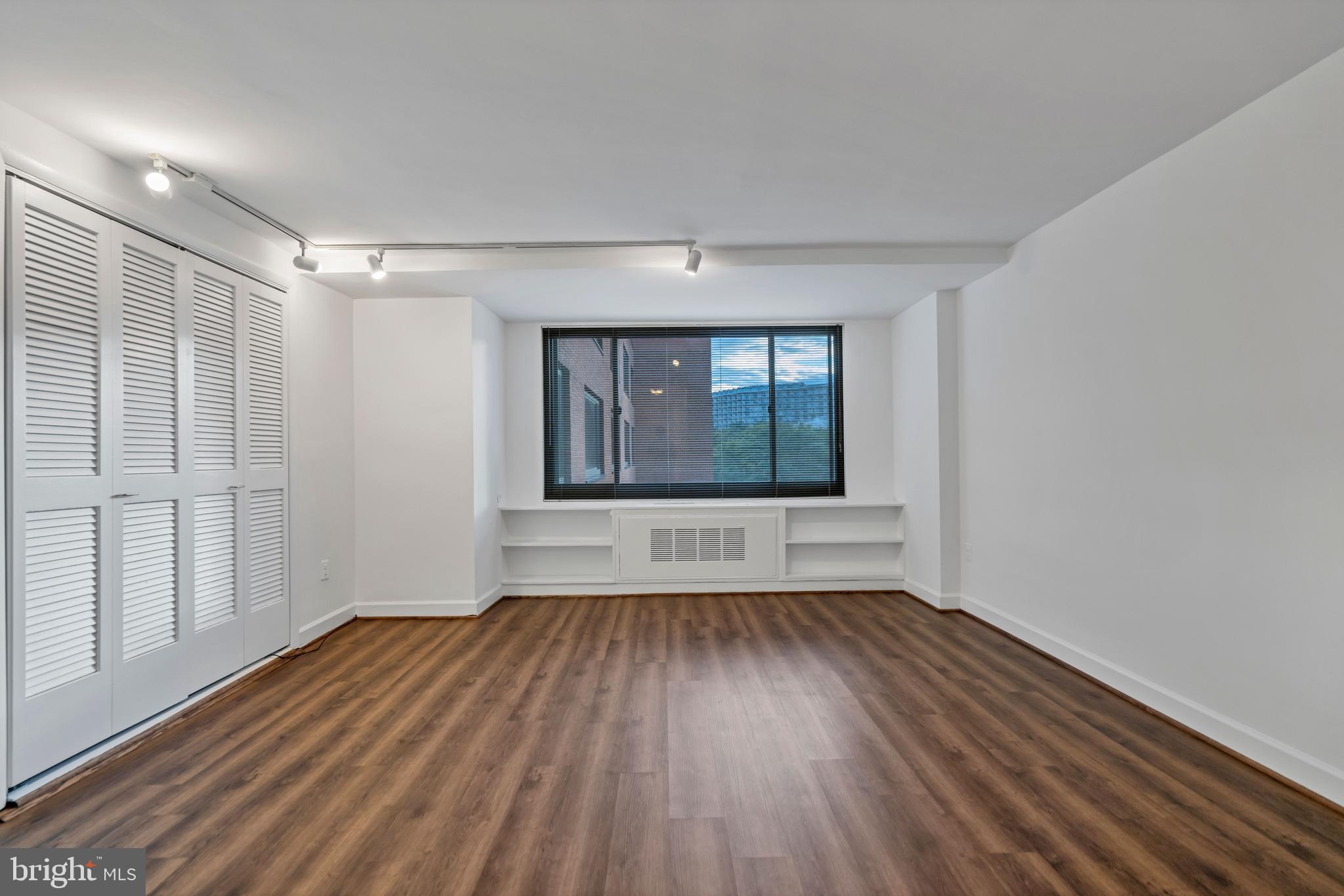 wooden floor in an empty room with a window