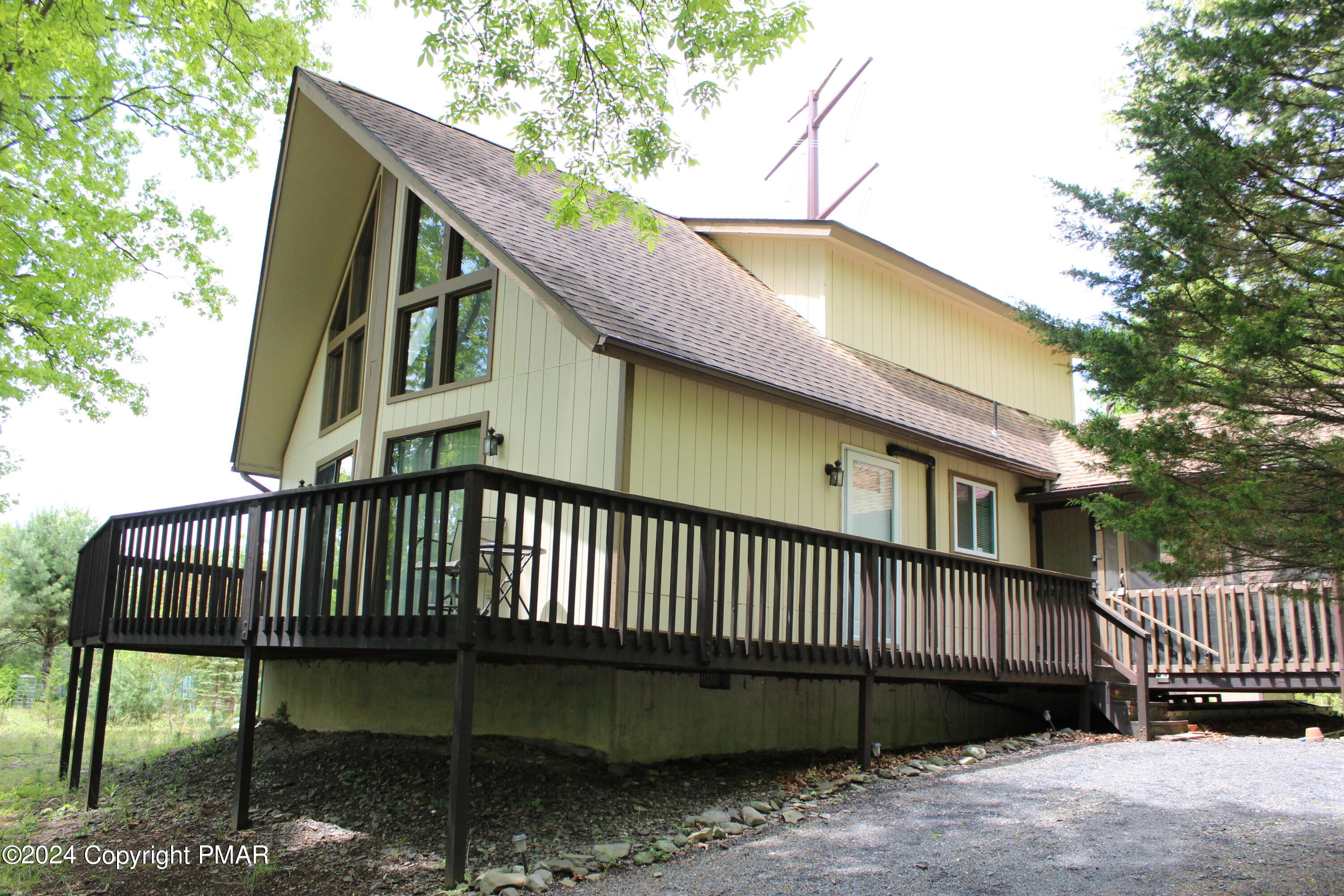 a view of a house with a wooden deck