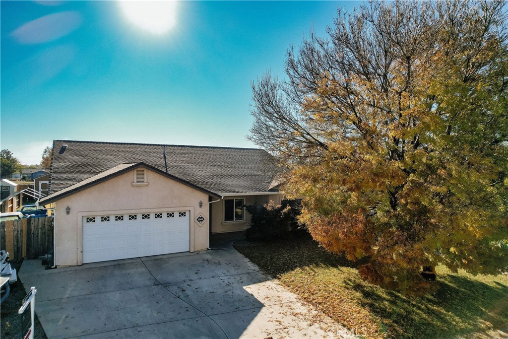 a view of a house with a yard and garage