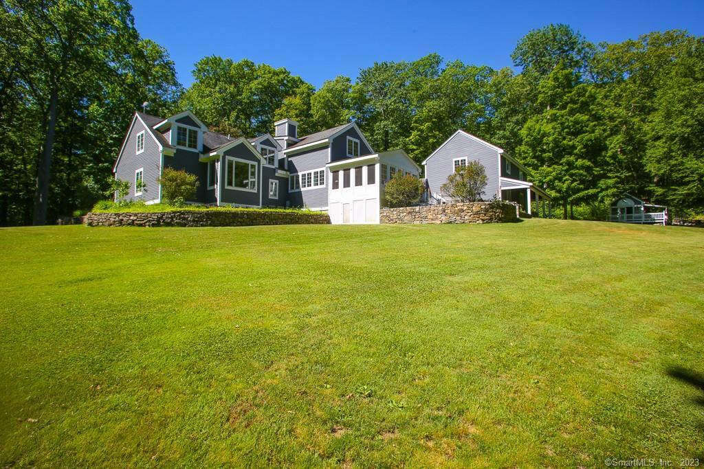 a front view of a house with yard and swimming pool