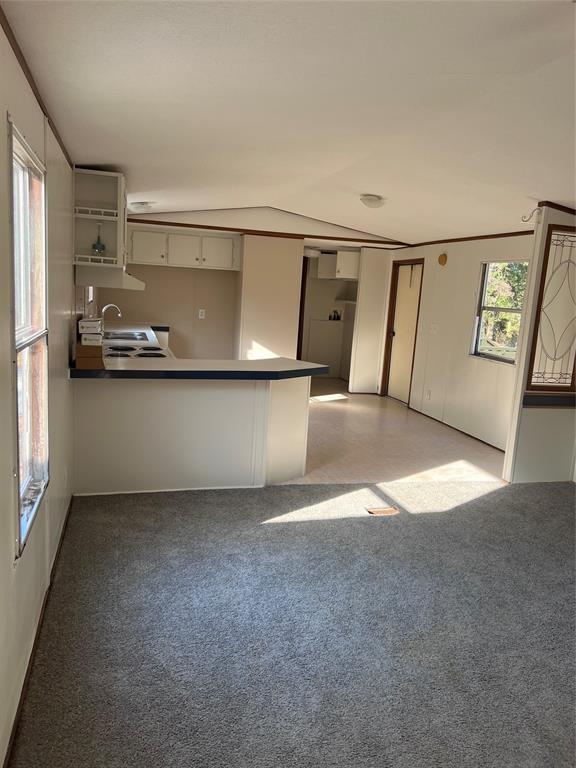 a view of a hallway with kitchen