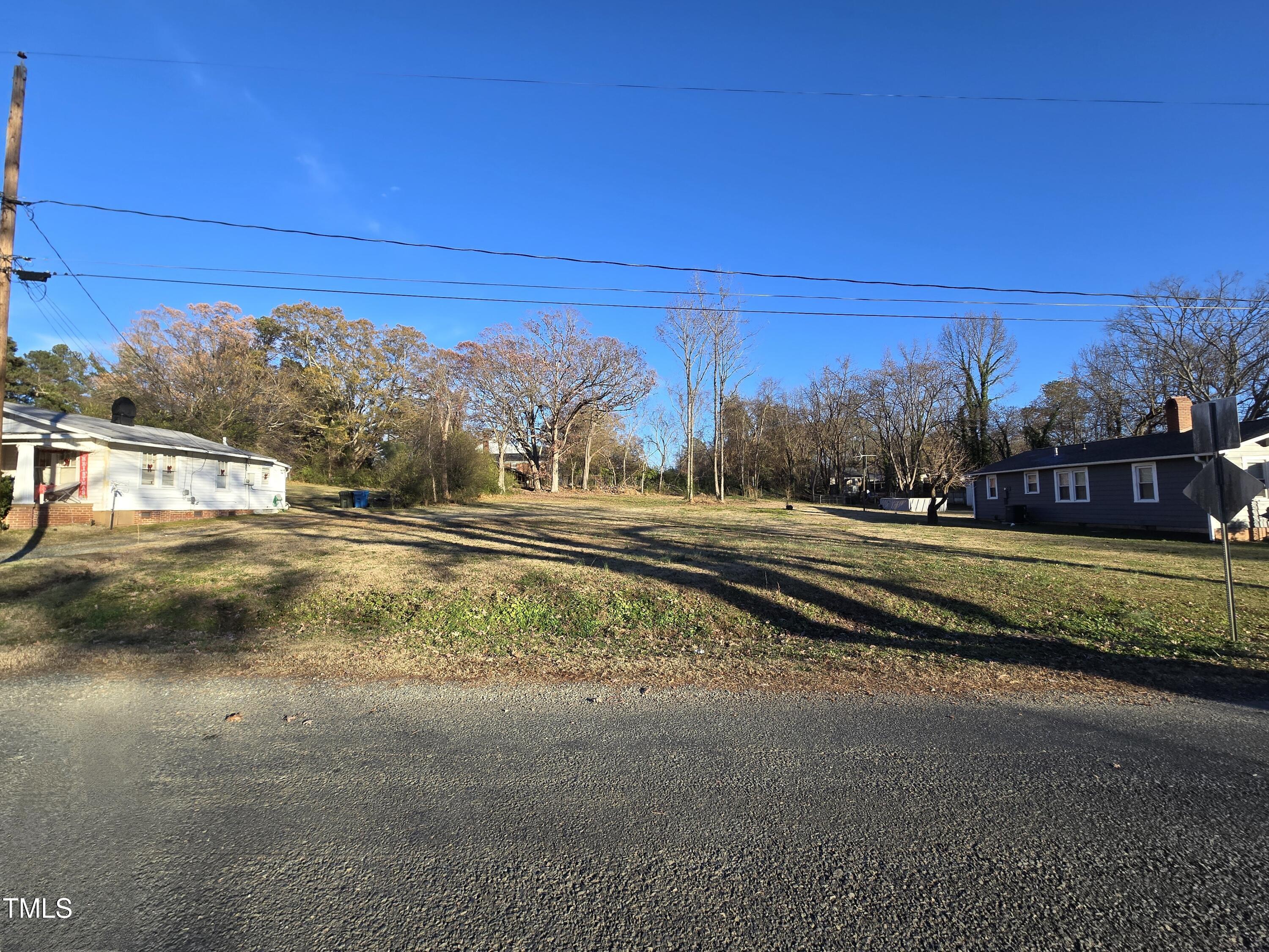 a view of city street with a house in the background