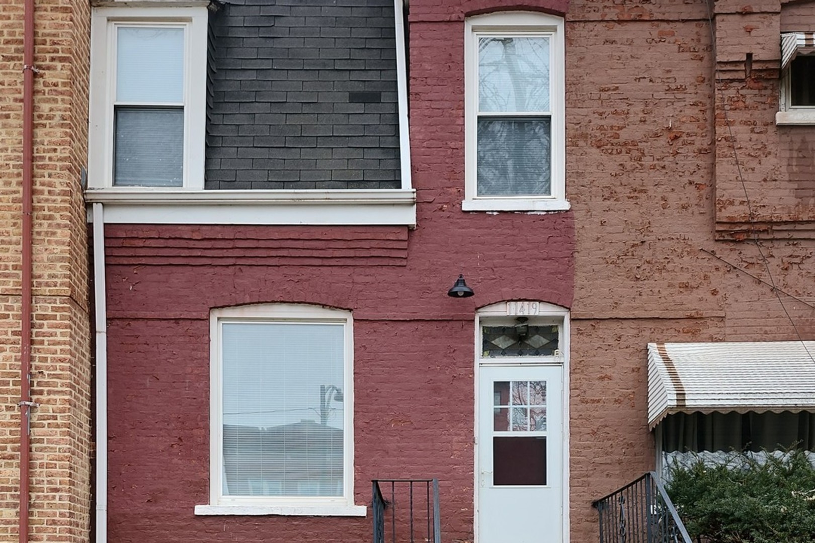 a front view of a building with a brick wall