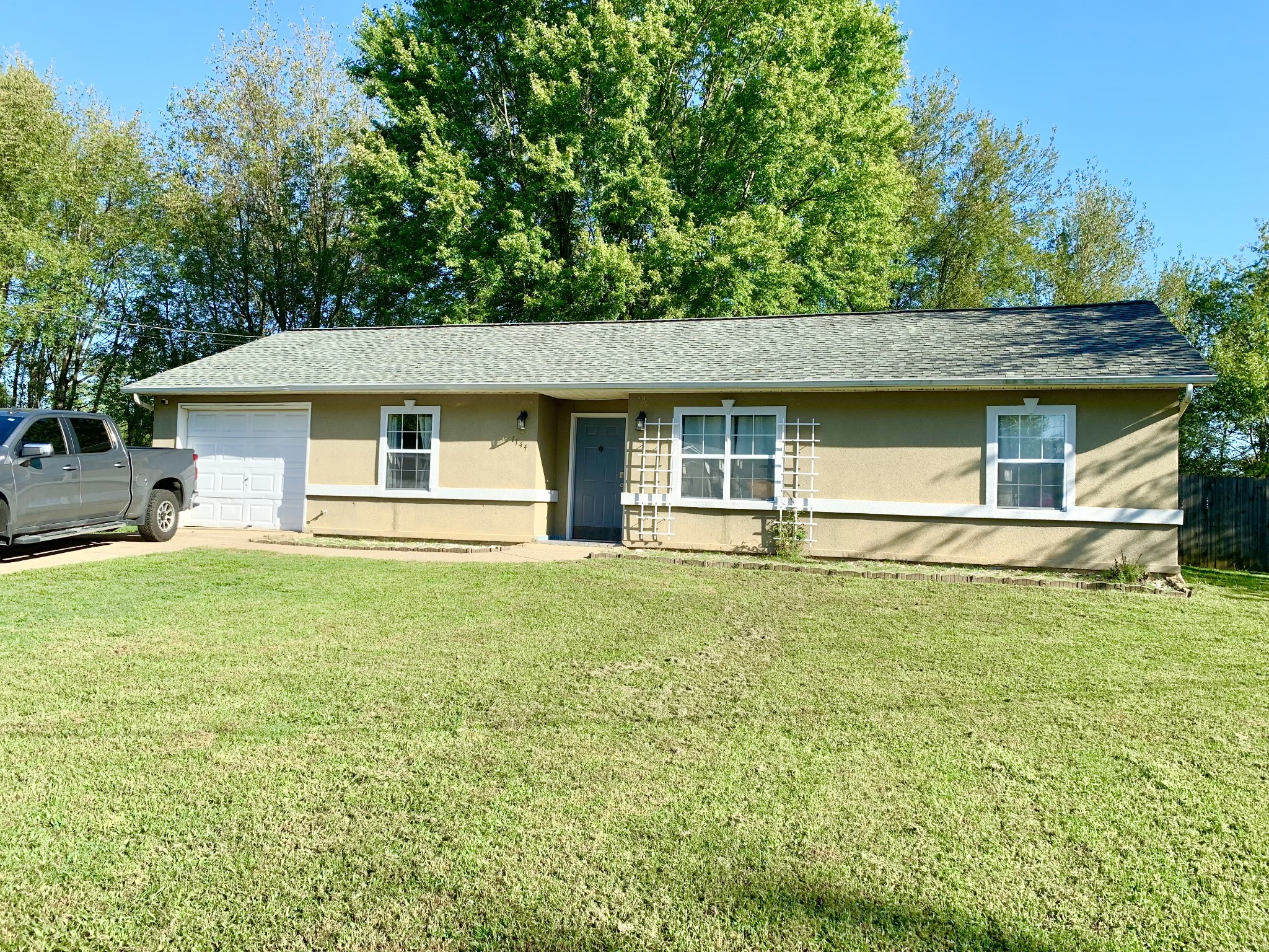 a front view of a house with a garden