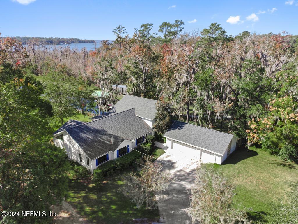 an aerial view of a house with yard and outdoor seating