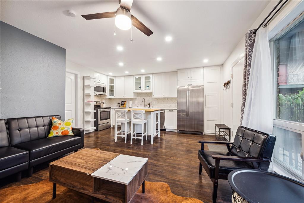 a living room with lots of furniture and kitchen view