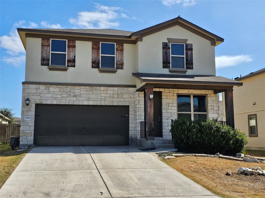 Front of home. Above garage is bedroom #2 and loft. Front porch with window to Office and upstairs bedroom #3