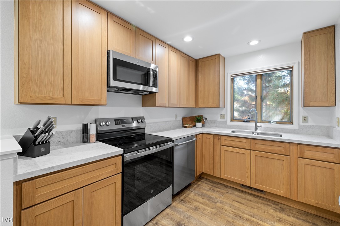 a kitchen with a sink stove and microwave