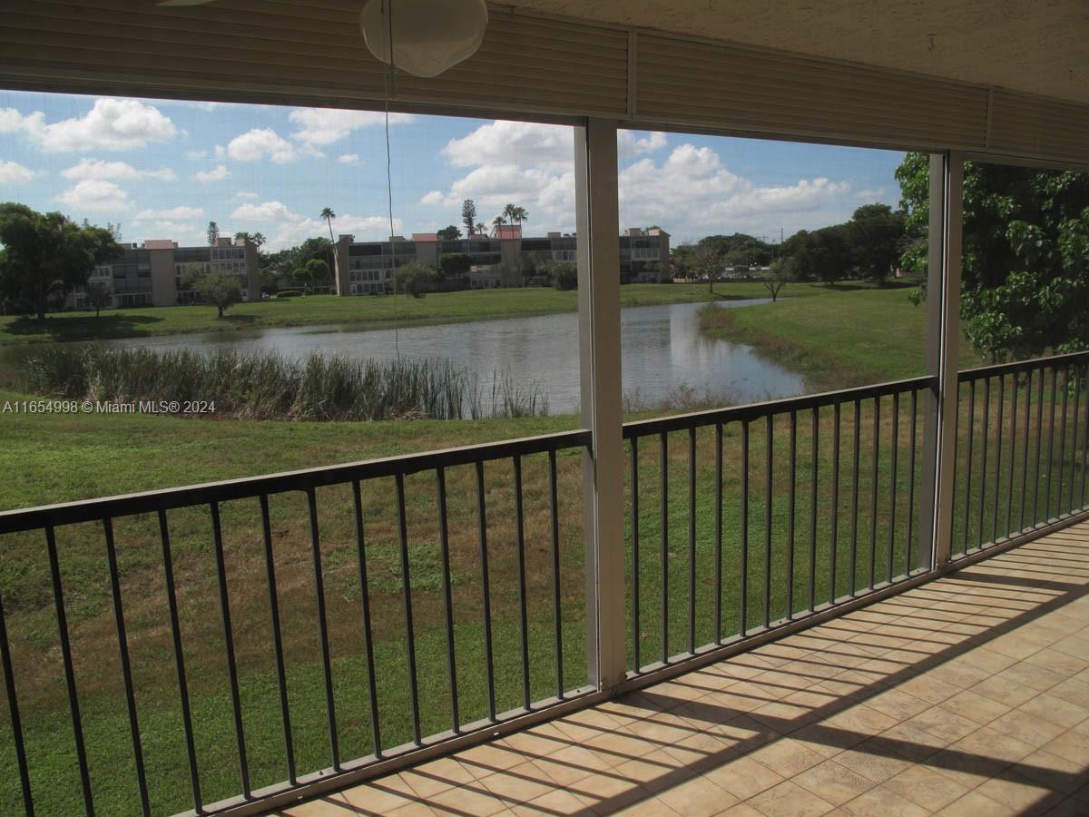 a view of a wooden deck next to a yard