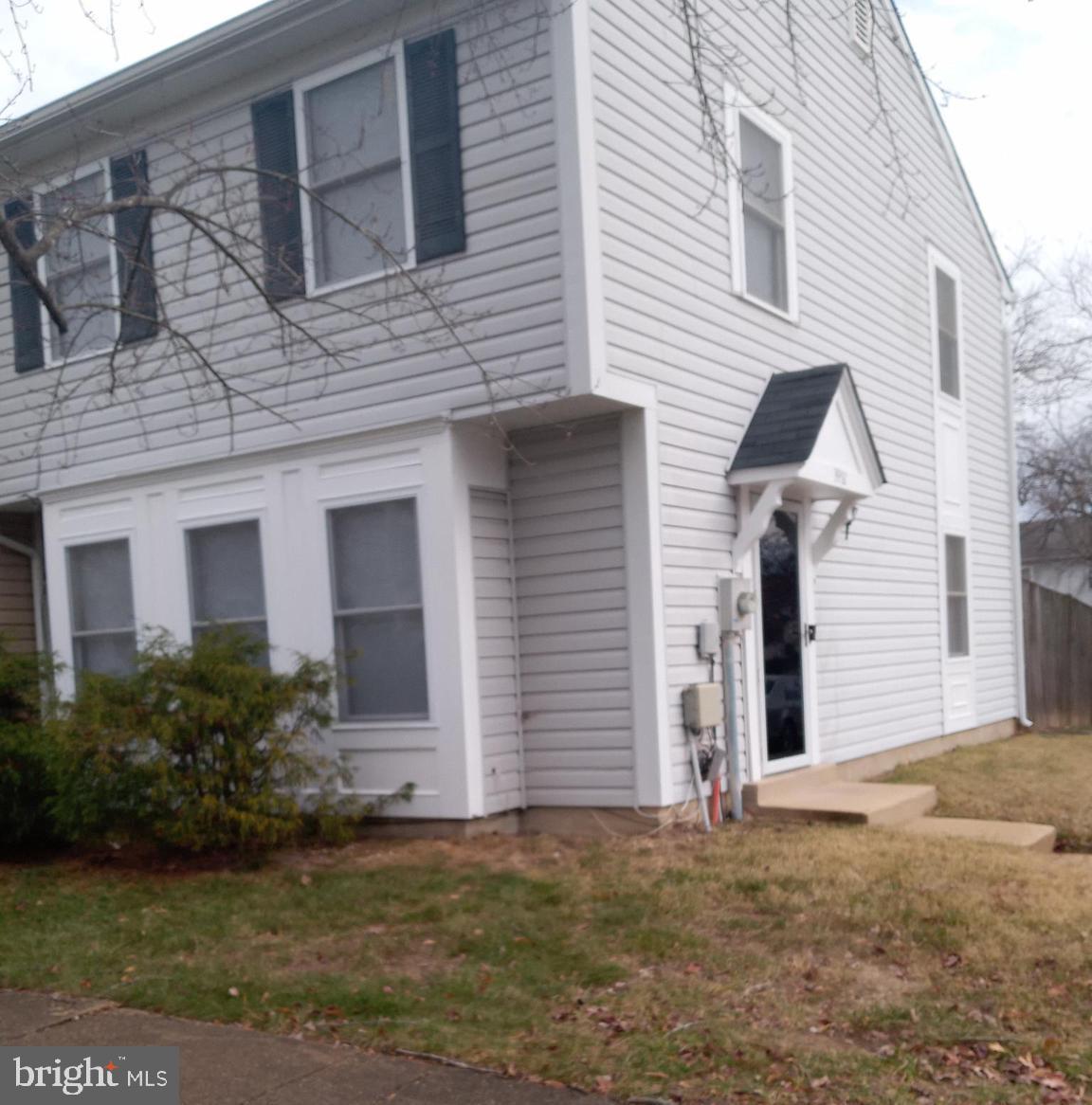 a view of a brick house with a yard