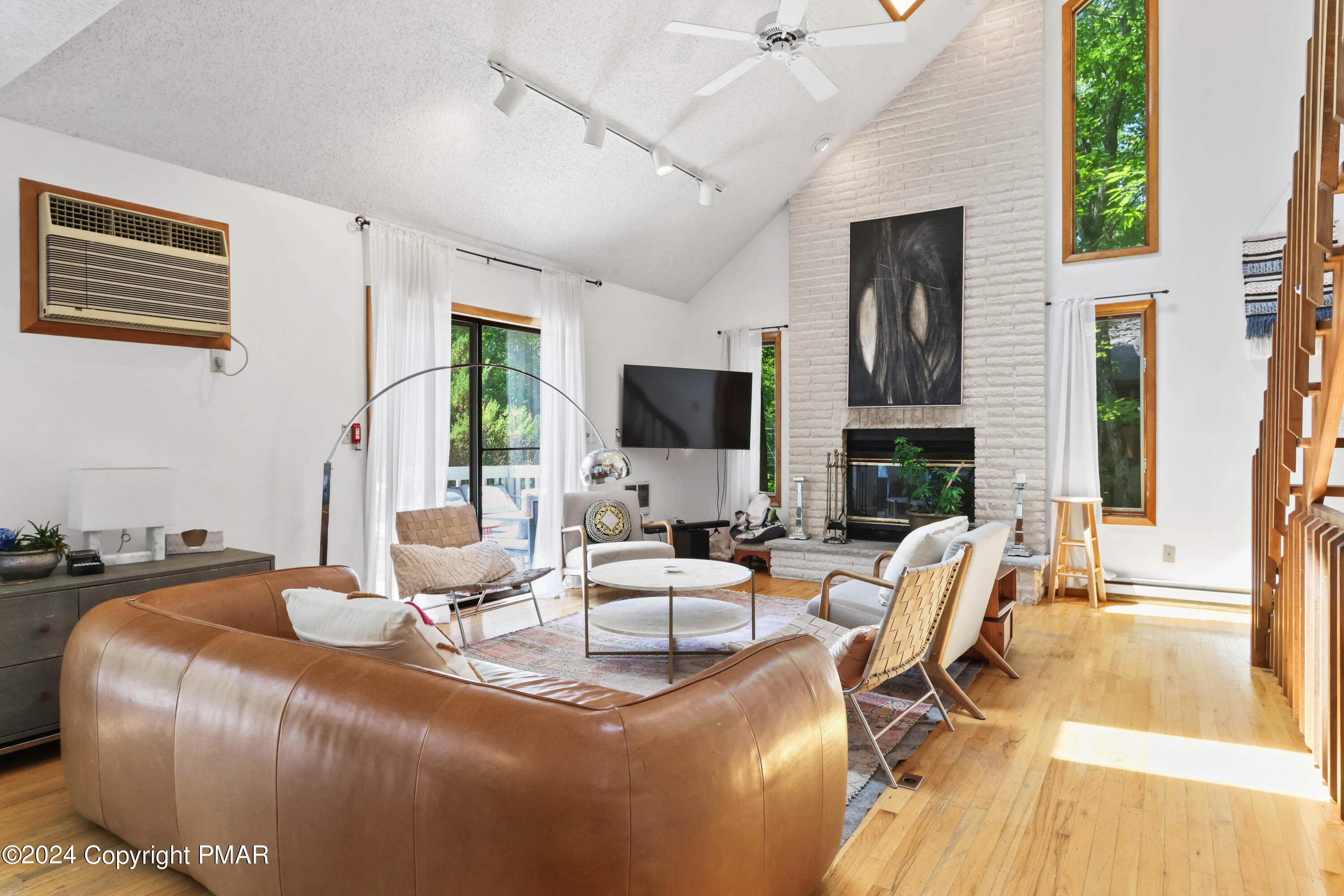 a living room with fireplace furniture and a flat screen tv