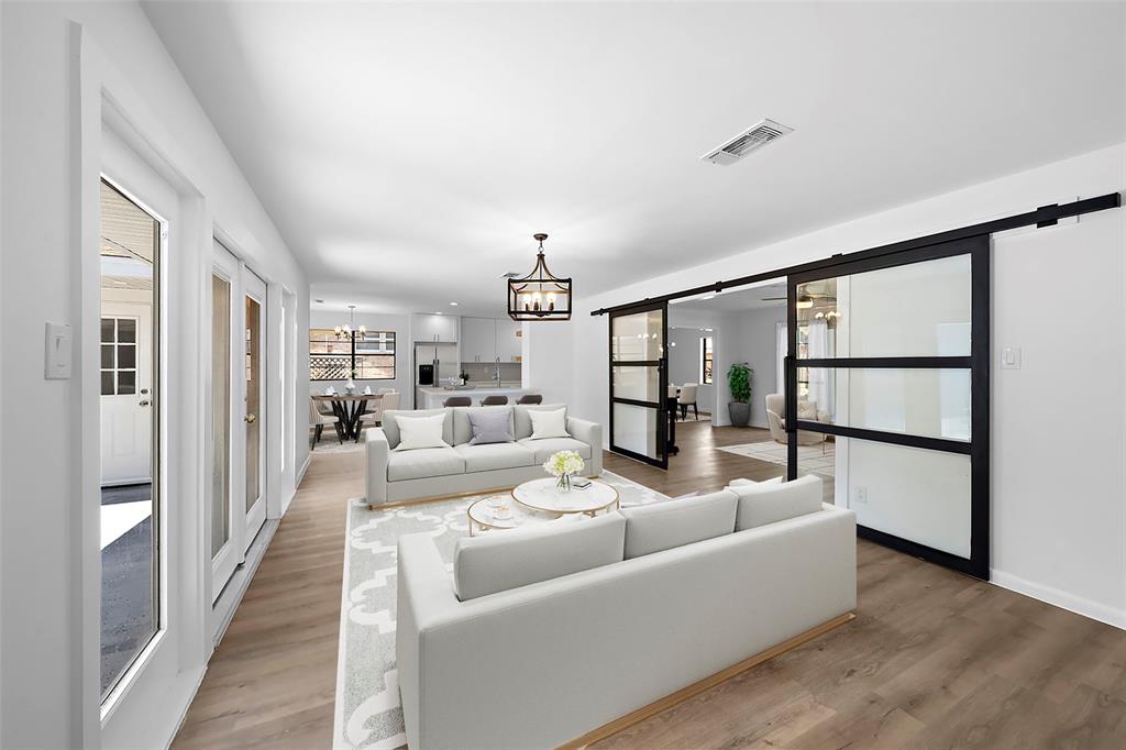 a living room with furniture wooden floor and a table