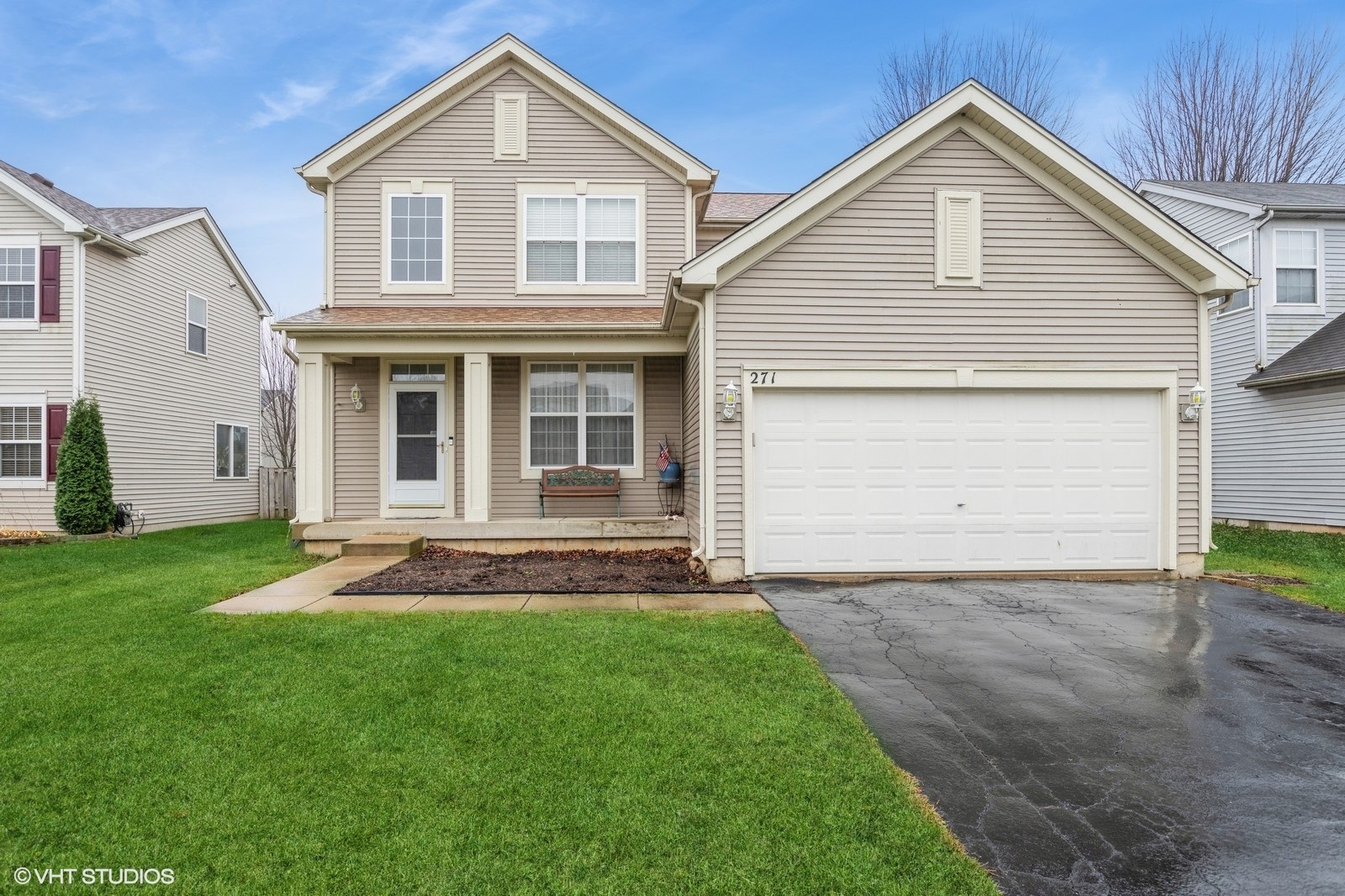 a front view of a house with a yard and garage