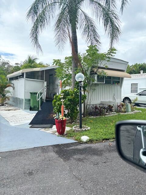 a front view of a house with garden and plants