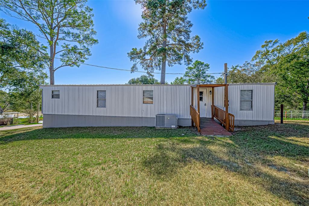 a view of a house with a yard and deck