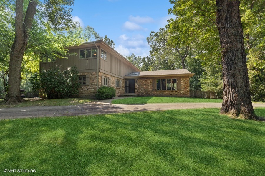 a view of house with a yard