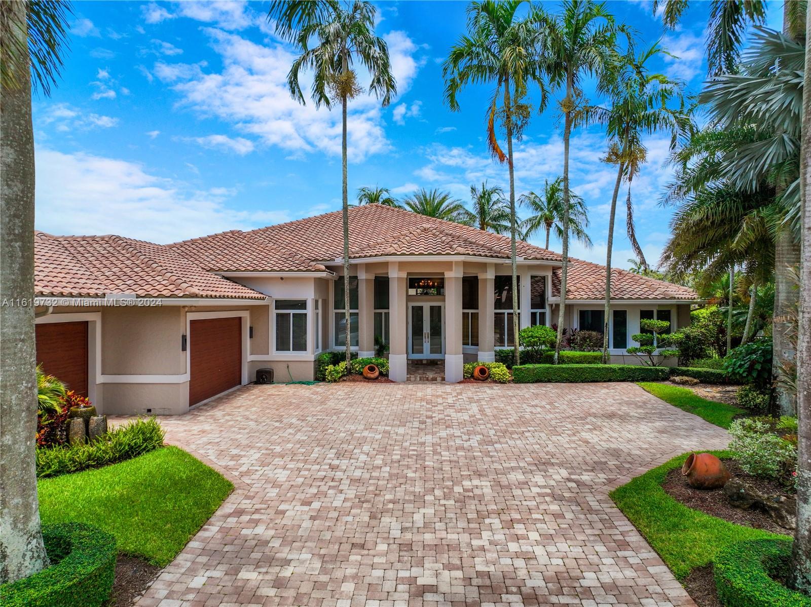 a front view of a house with a garden