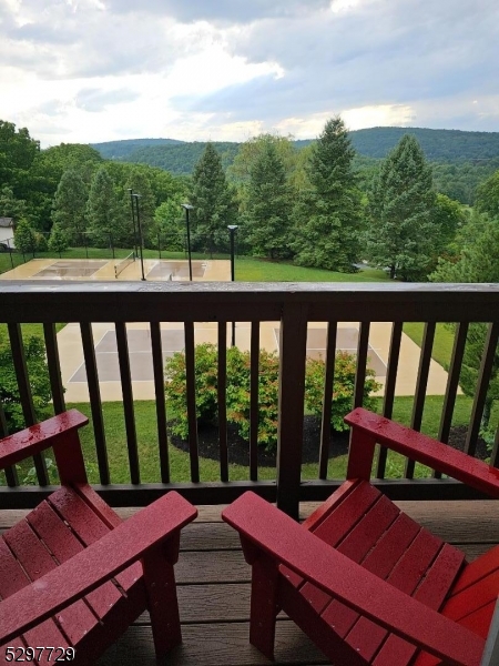 a view of a patio with lawn chairs and a table