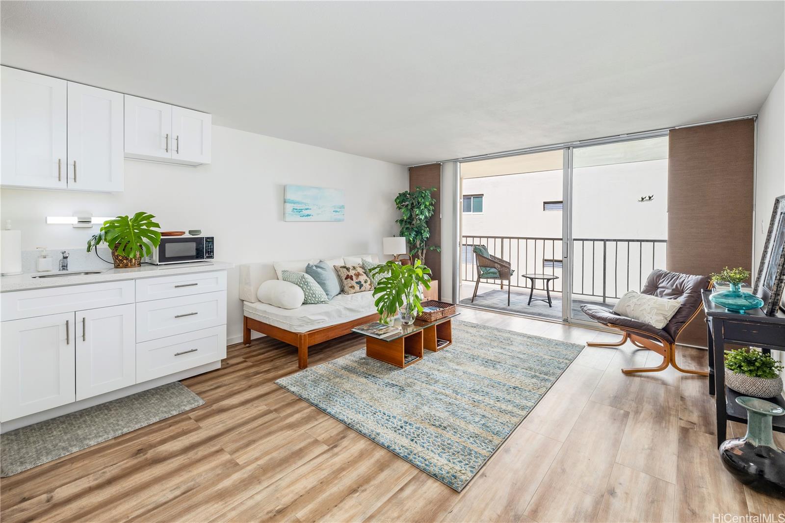 a living room with furniture and wooden floor