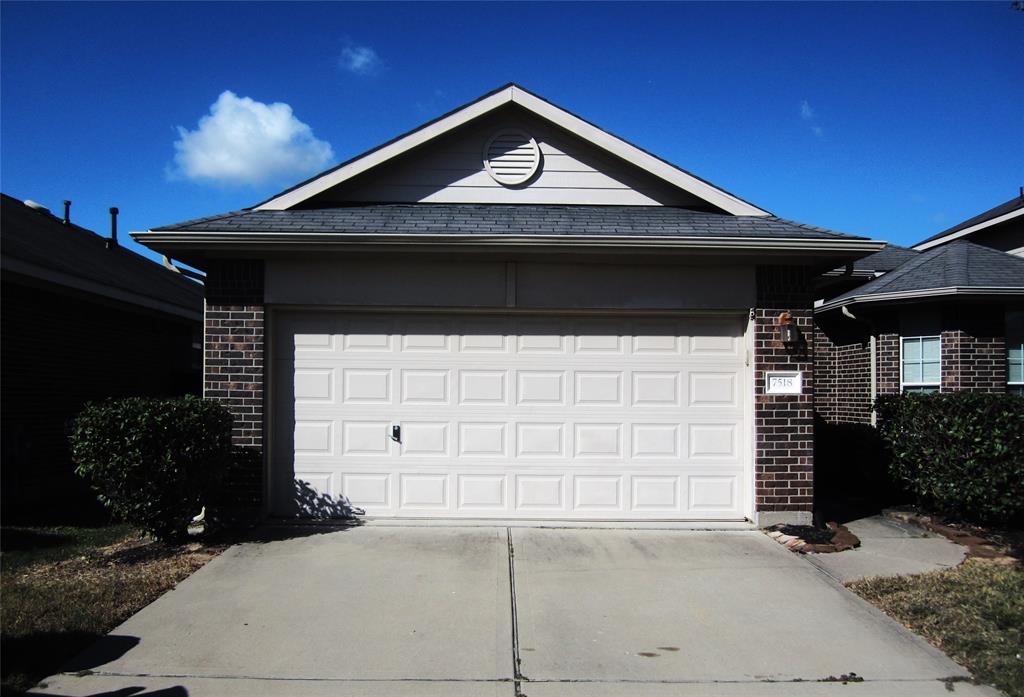 a front view of a house with garage