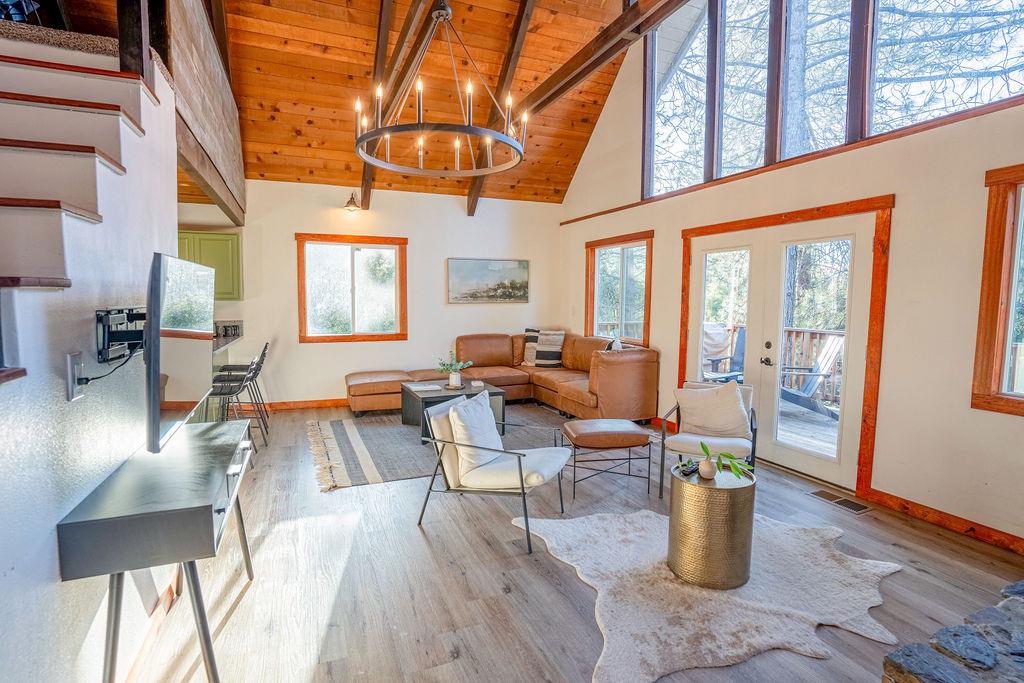 a living room with furniture a wooden floor and a large window