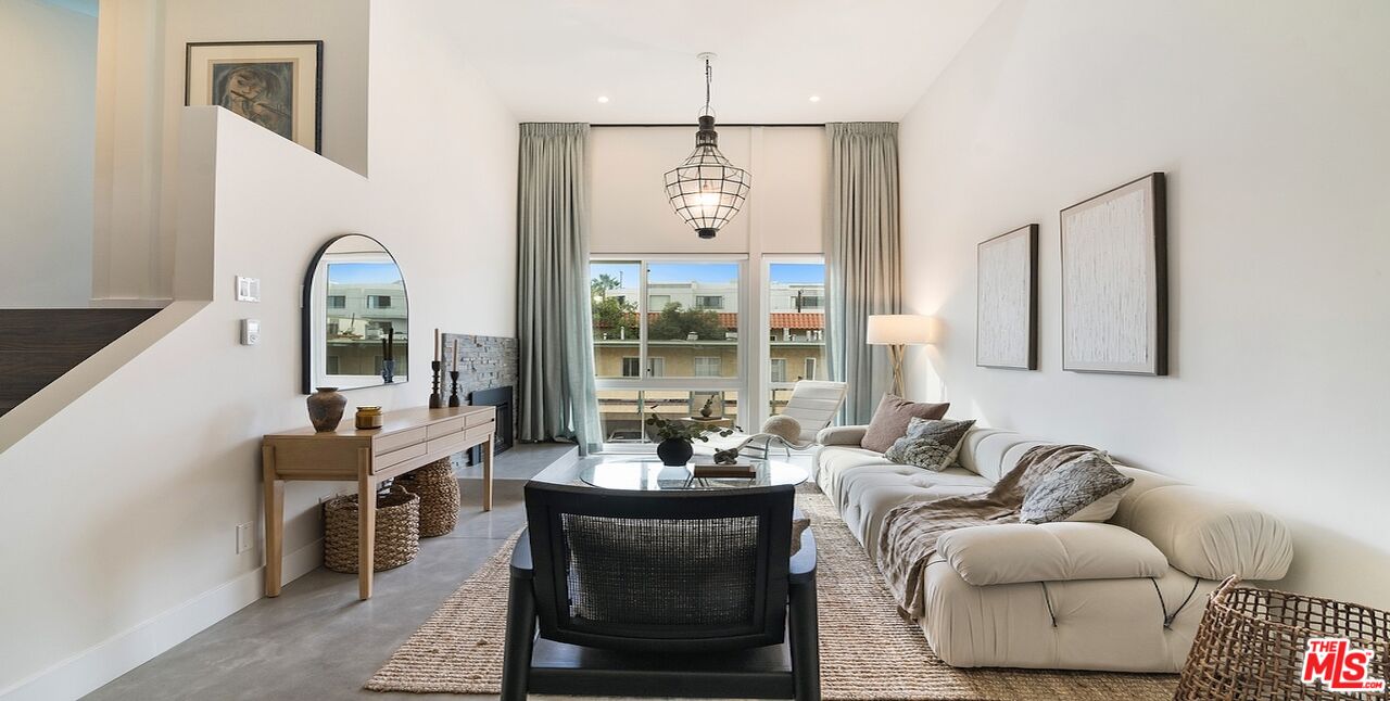 a living room with furniture and a chandelier