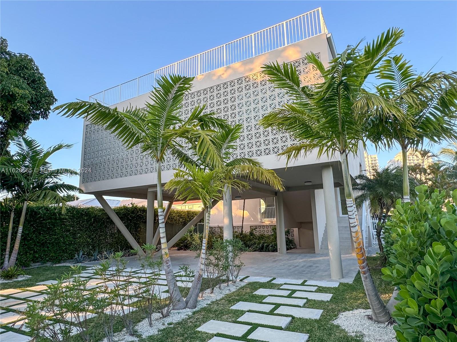 a view of house with palm trees