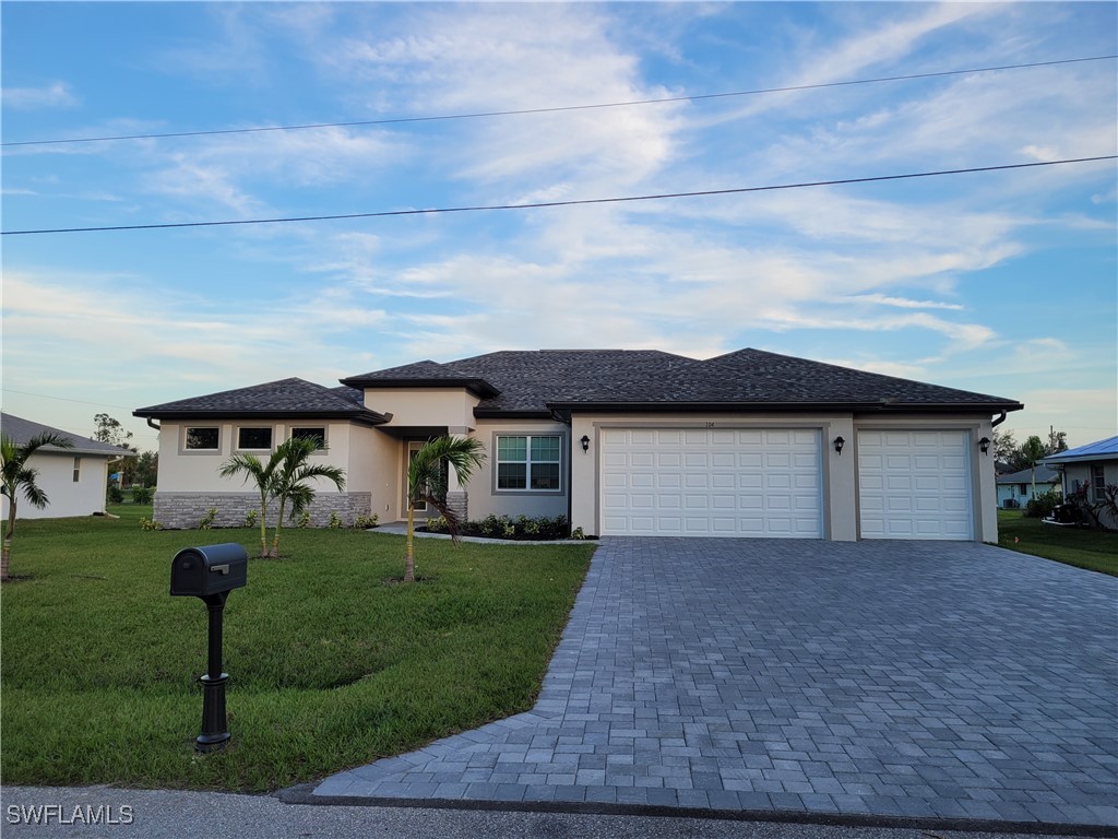 a front view of house with yard and green space